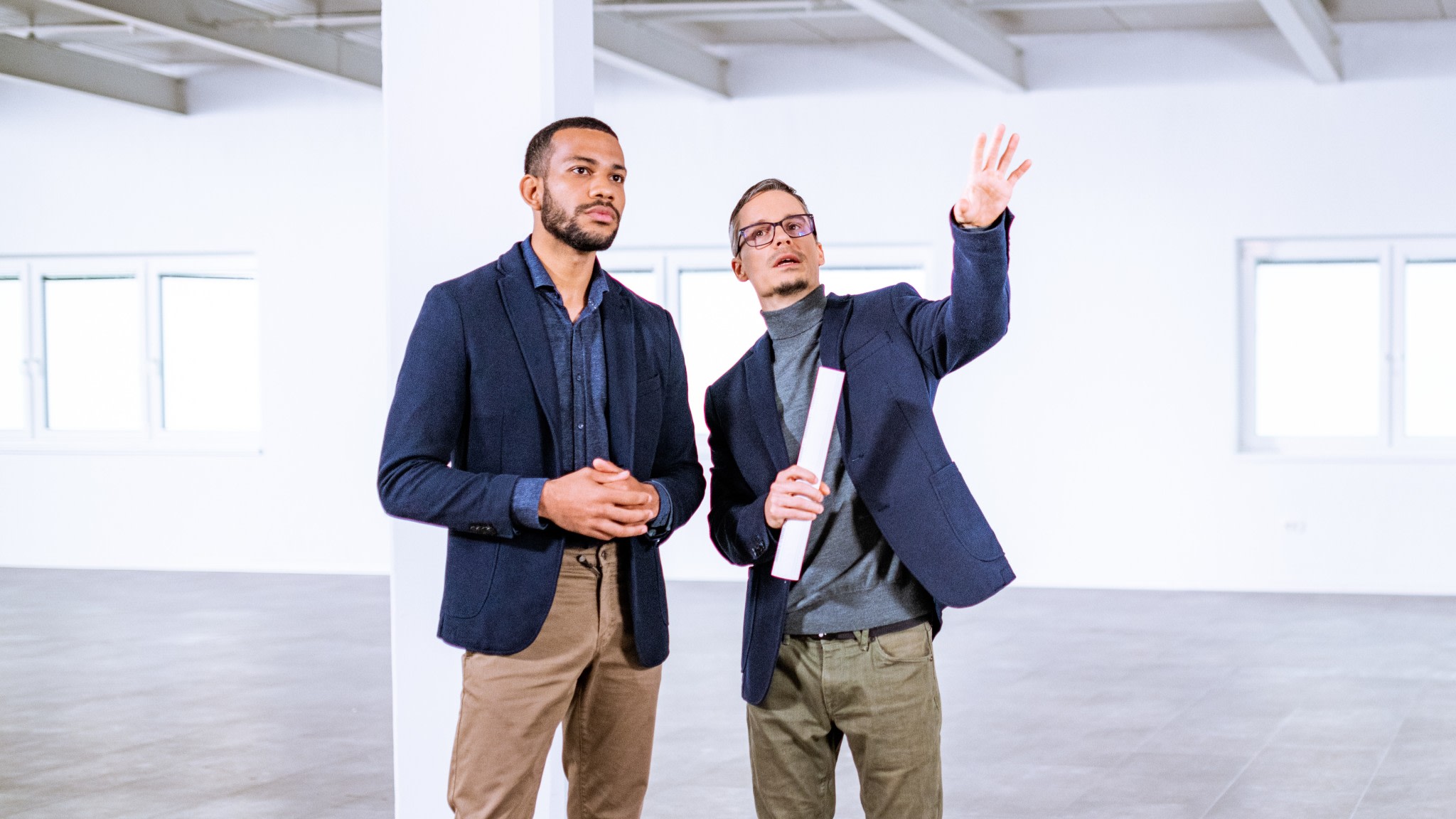 Real estate agent with a client in an empty office building.