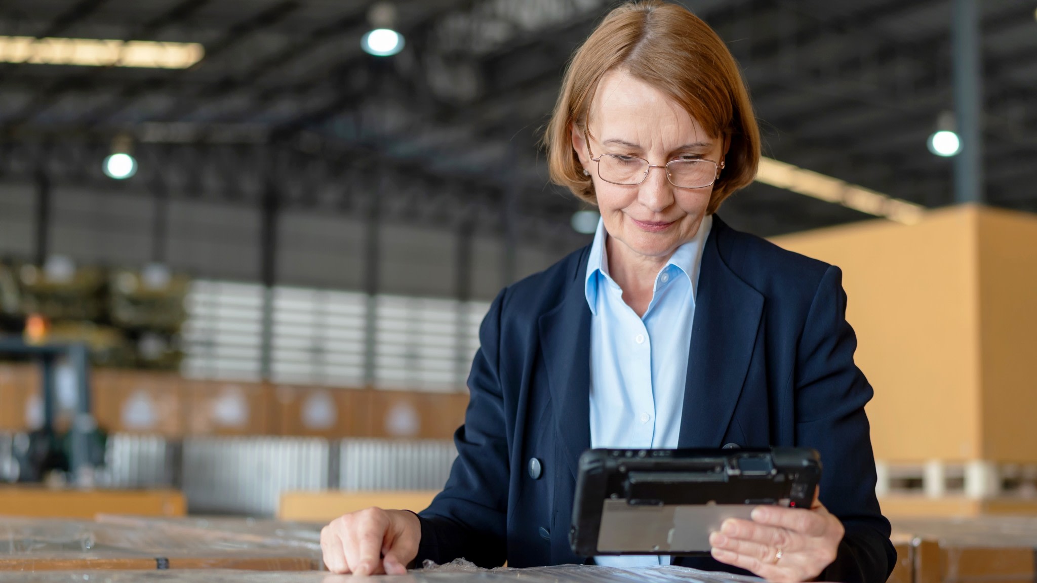 Businesswoman in warehouse.