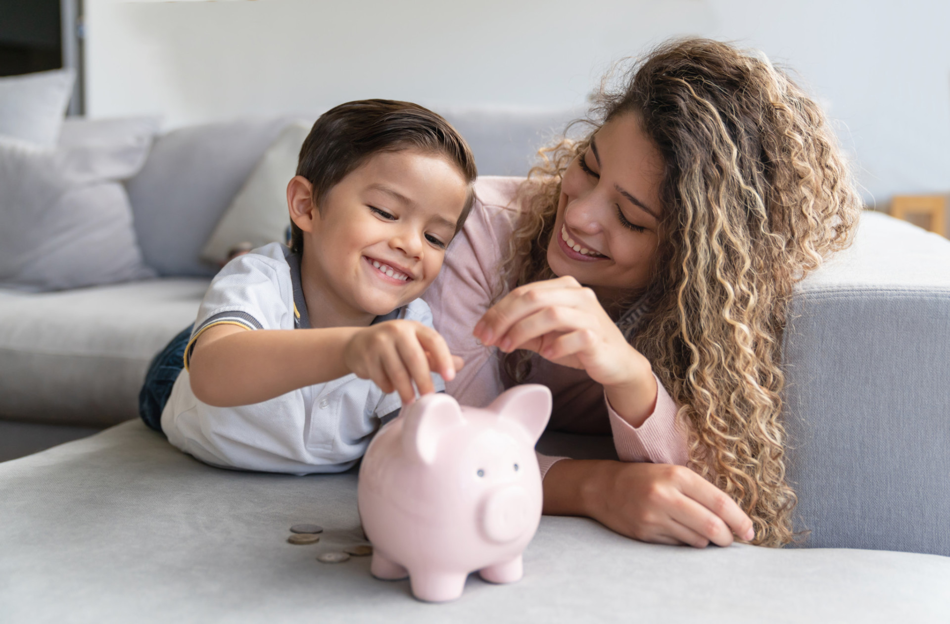 Mother and child saving money.