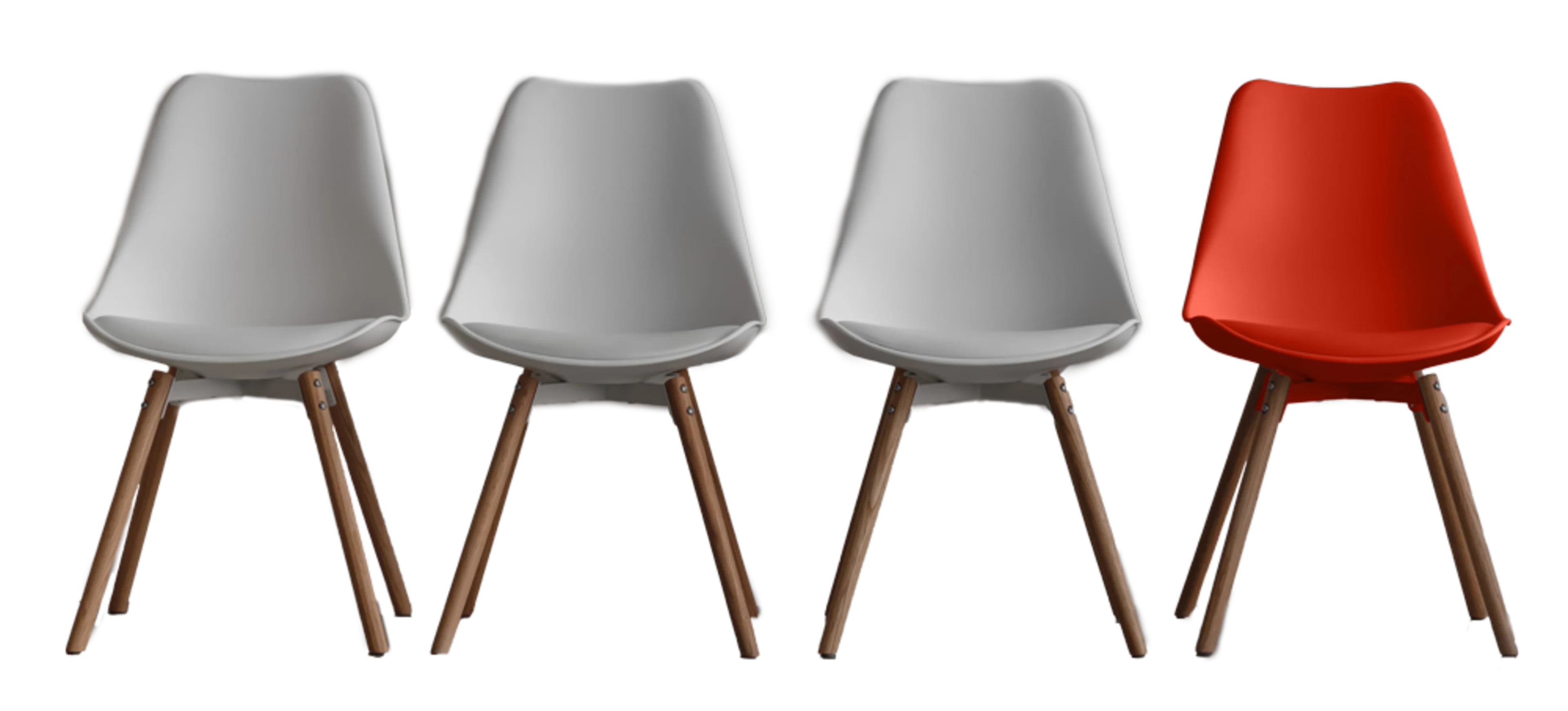 A row of four mid-century modern Eames shell chairs, three white and one orange