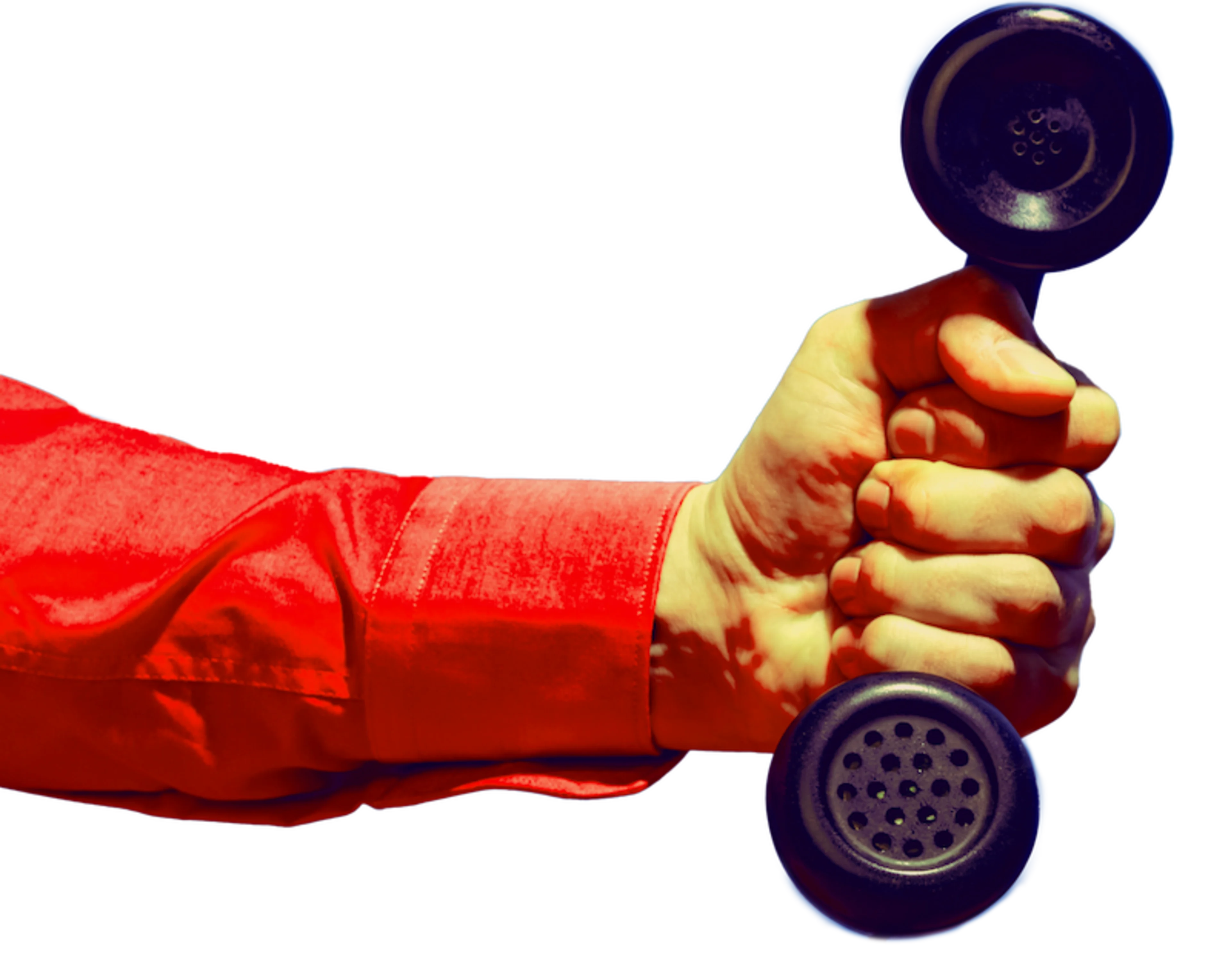 Man's arm holding a corded phone handset