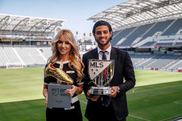 a man and a woman holding a trophy