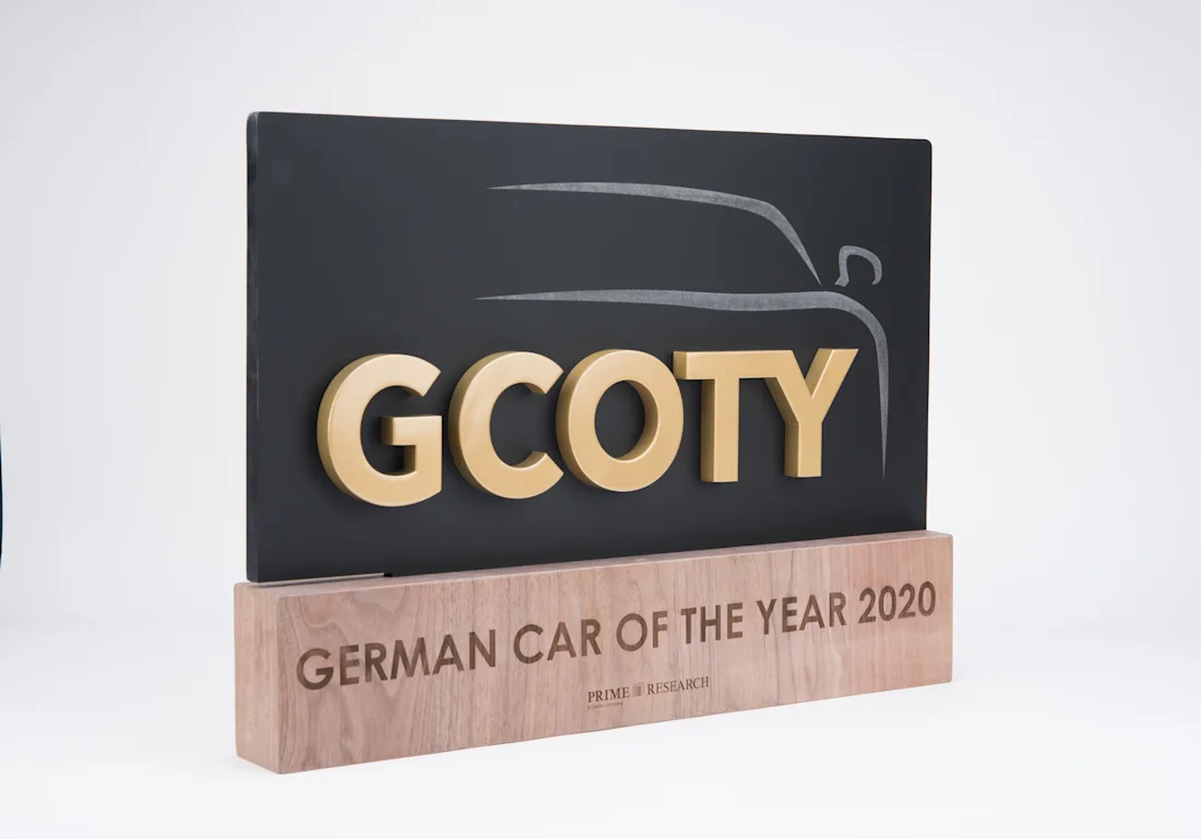 German Car of the Year 2020 award with layered lettering on a wood base