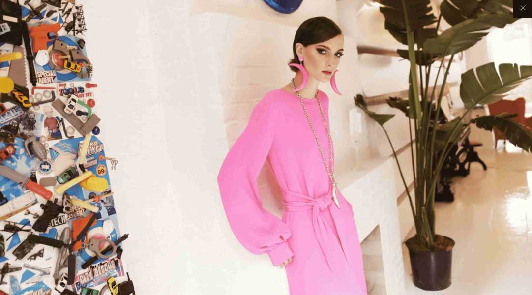 Instagram model wearing pink dress and earrings