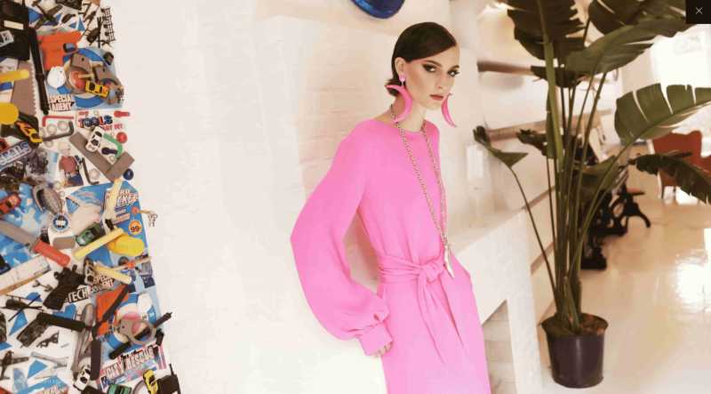 Instagram model wearing pink dress and earrings