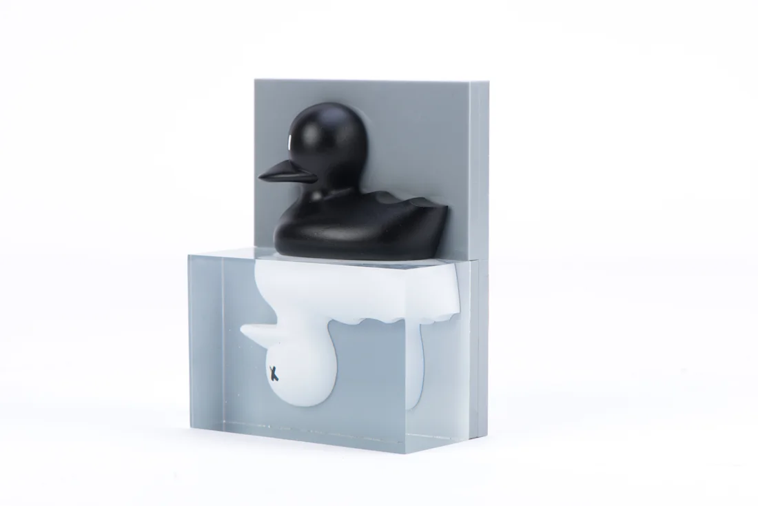 A black duck trophy perched on a grey display block for a hackathon