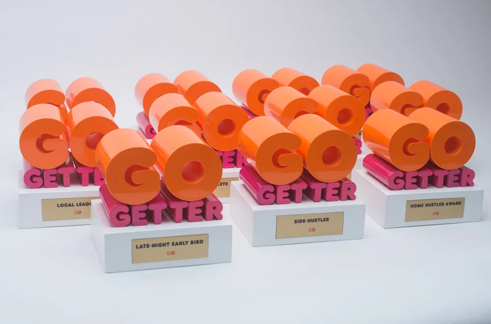 A set of orange Go Getter trophies with personalized name plates