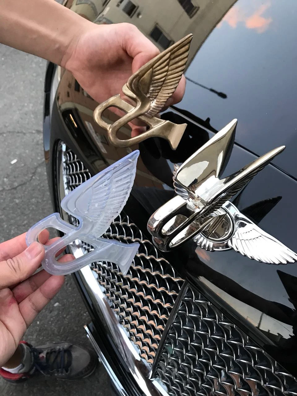 Custom logo objects shown before and after metal plating