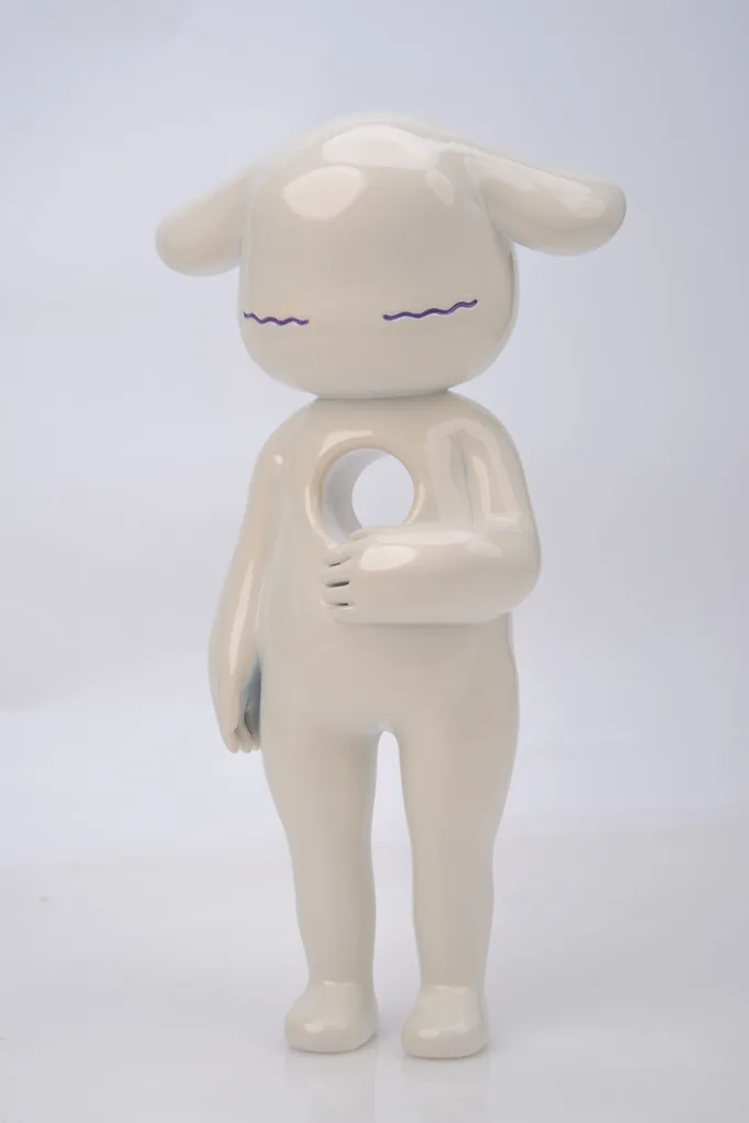 Minimal white figure with long ears, closed eyes and a heart-shaped opening in its body