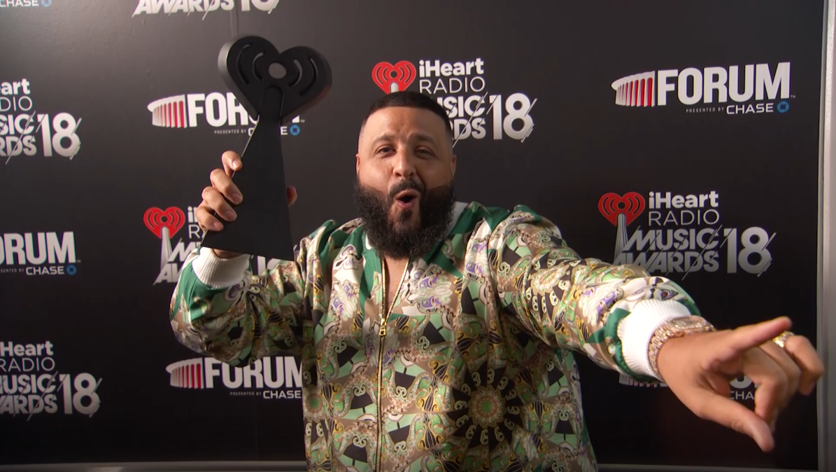 DJ Khaled holding the iHeart Radio trophy