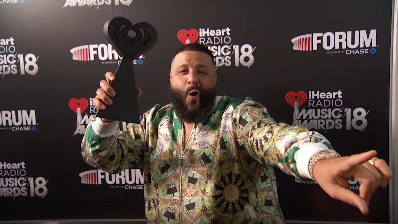 DJ Khaled holding the iHeart Radio trophy
