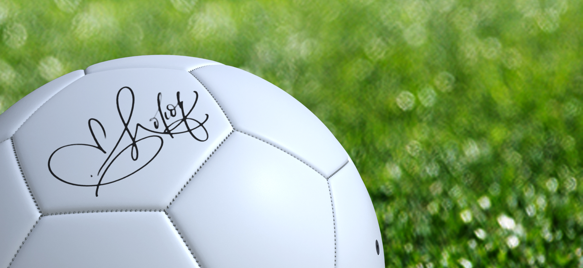 Signed football on grass