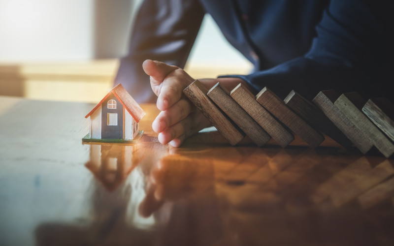 man-stopping-dominoes