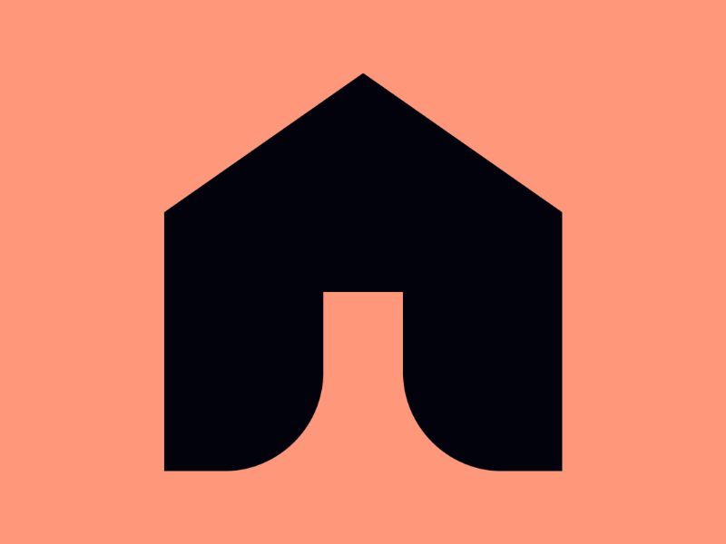 A black icon of a house on a peach coloured background.