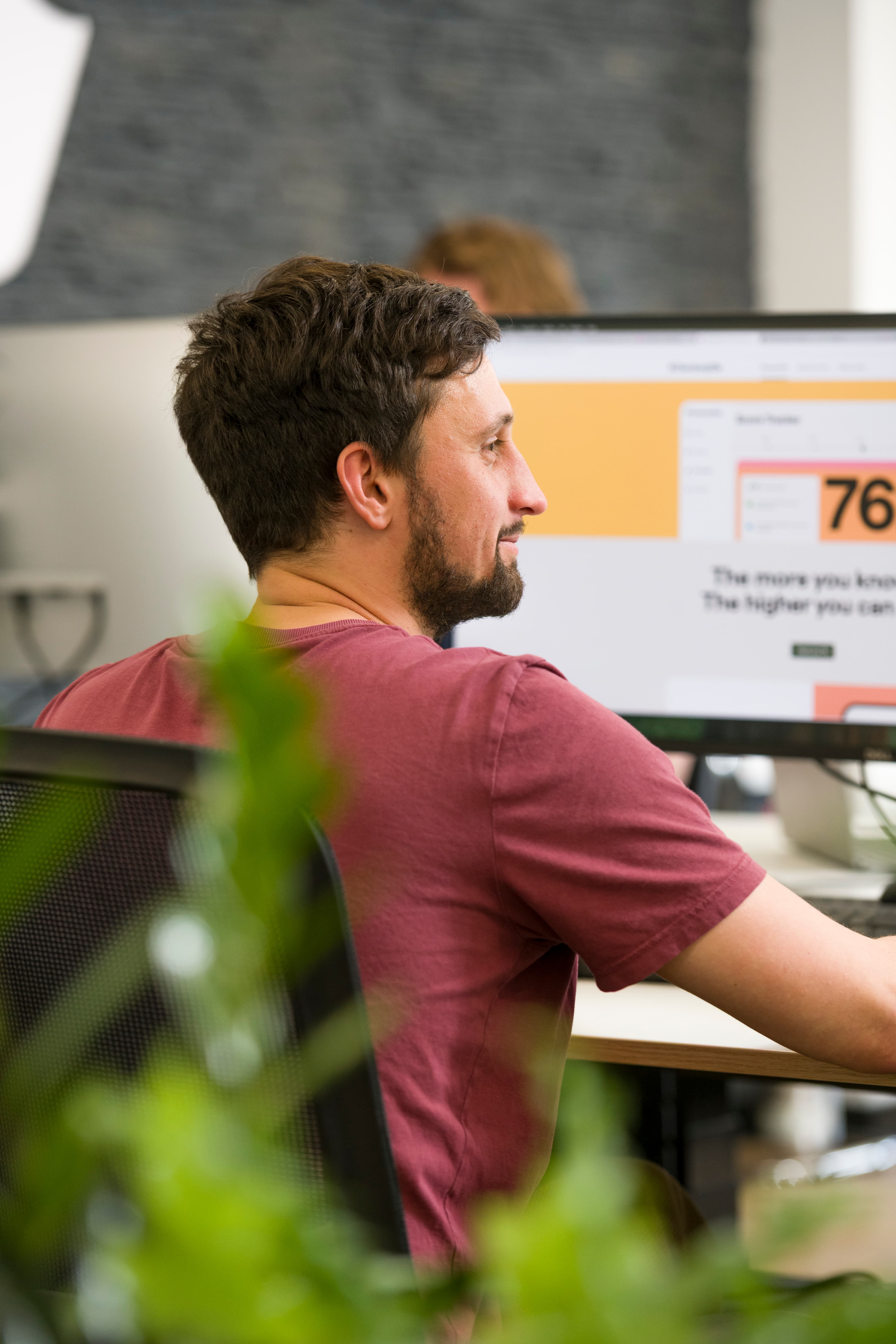 Person smiling while at their desk