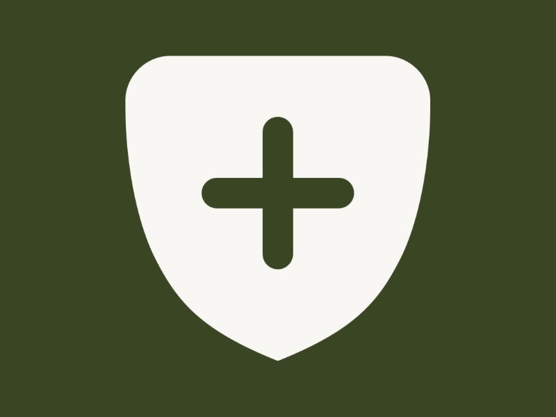 A white shield on an evergreen background.