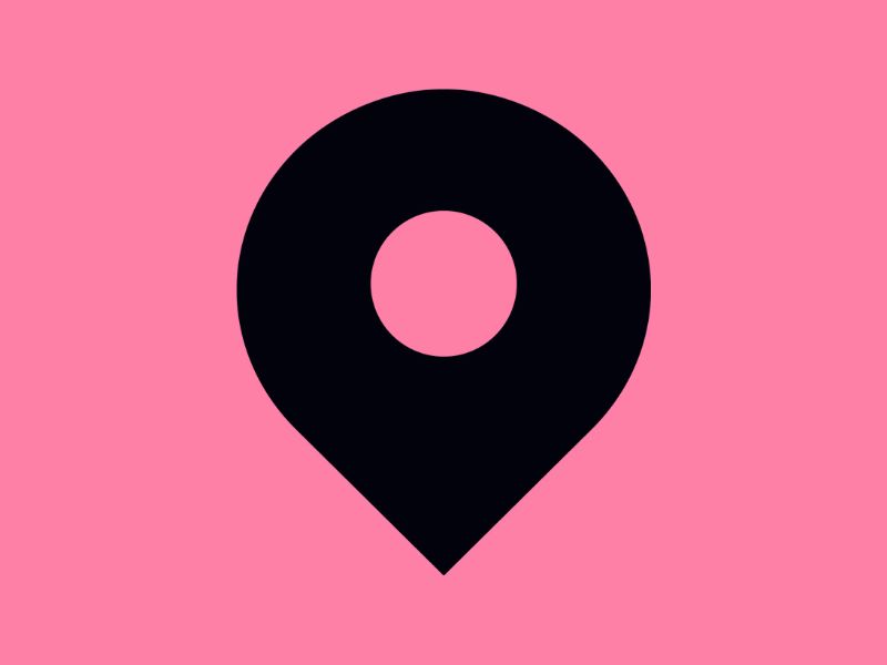 A black location pin on a pink background.
