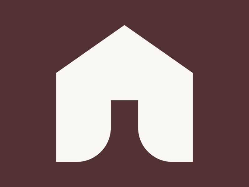 A white house on an earth brown background.