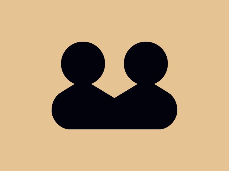 A black image of two people on a taupe background.