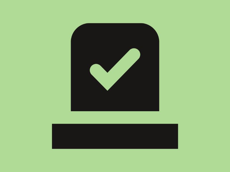 A black ballot paper on a mint green background.