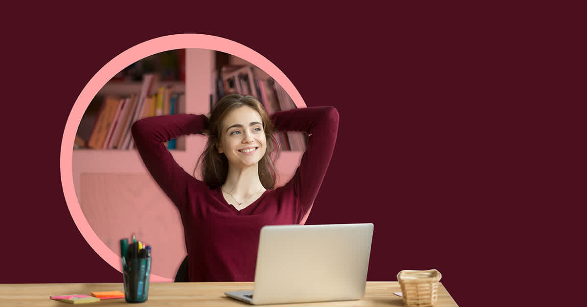 woman smiling at desk - how to negotiate paid parental leave