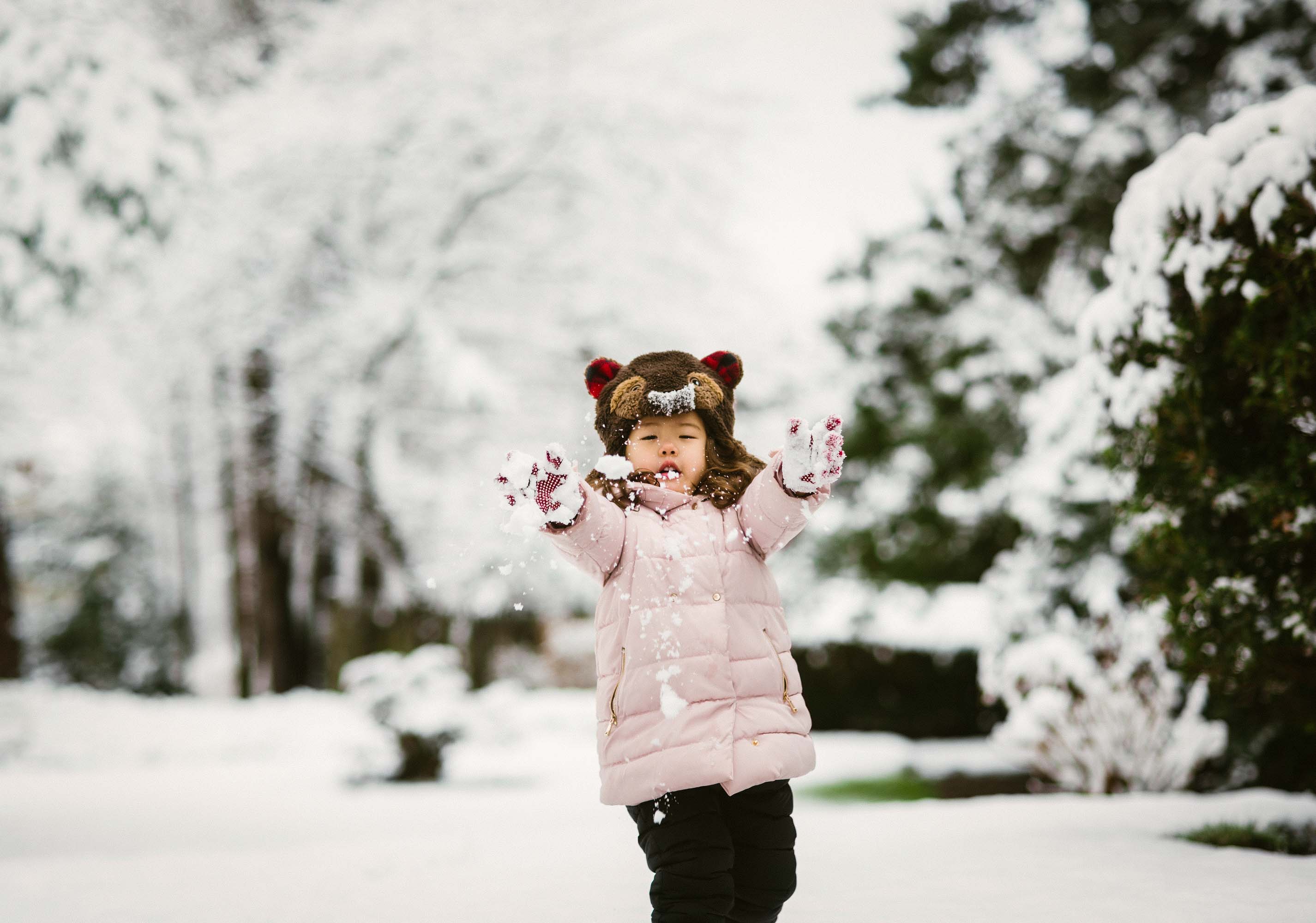what to know when you have a 4 year old - girl in puffy coat playing in the snow