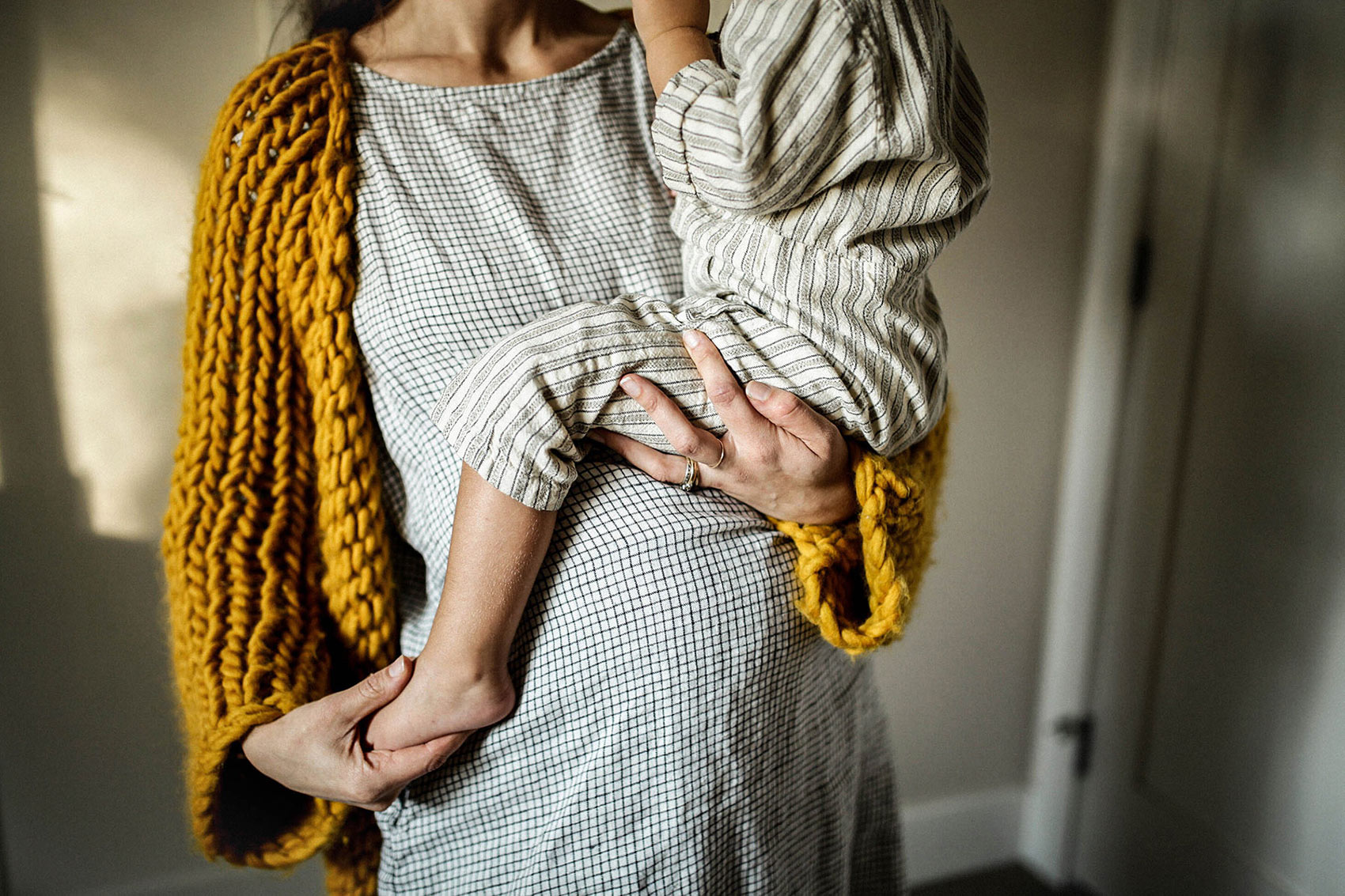 dealing with a high deductible health plan when giving birth - pregnant woman holding a toddler