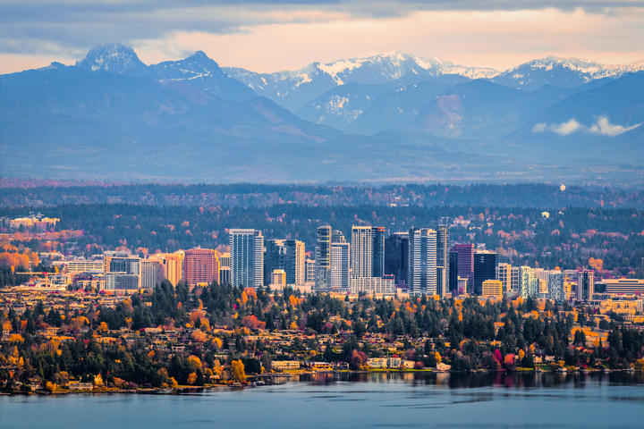 The Healthiest Cities in the United States for Families - Bellevue, WA skyline with snowcapped mountains in the background. 