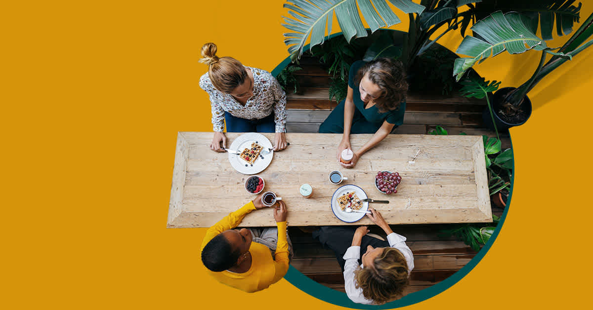 aerial view of people talking at a table - cities in American with the hardest working parents