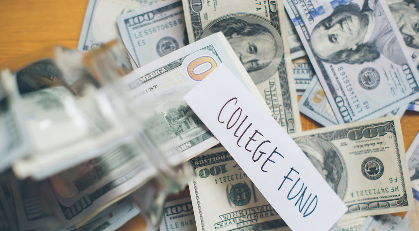 Numerous $100 bills (or Benjamins), along with a 'college fund' tag, are scattered around and inside a vase.