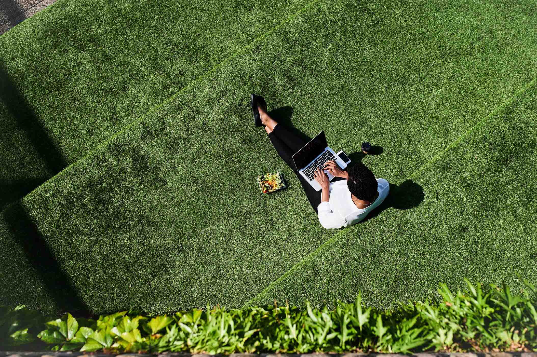 man on laptop outside - life insurance riders 101