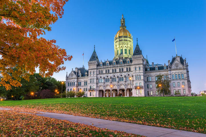 States with the best public schools - capitol building in Hartford, Connecticut with a tree with orange leaves during the fall in the foreground.