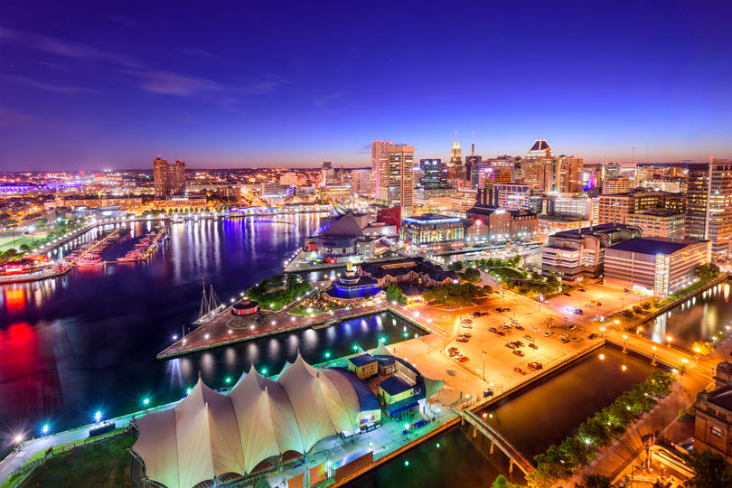 The Best-Paying Cities for Millennials - Baltimore, Maryland seaport skyline at sunset