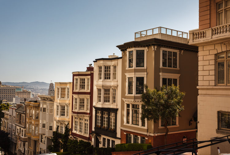 How Much Home Can Millennial Families Afford in These Top Cities? - San Francisco townhomes along a hilly street. 
