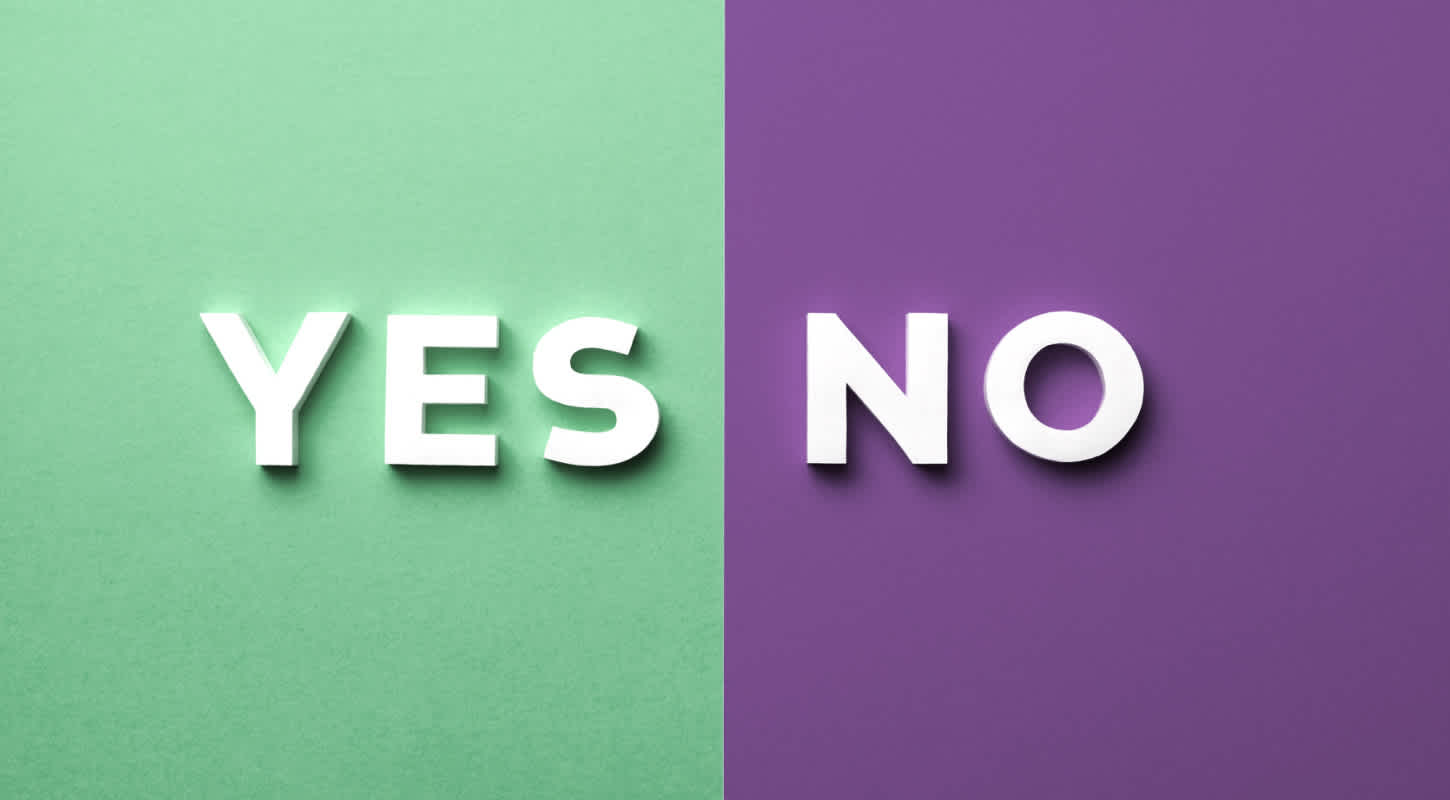 A bicolor rectangular block is split down the middle. White text reads YES against a green background, and NO against a purple background.
