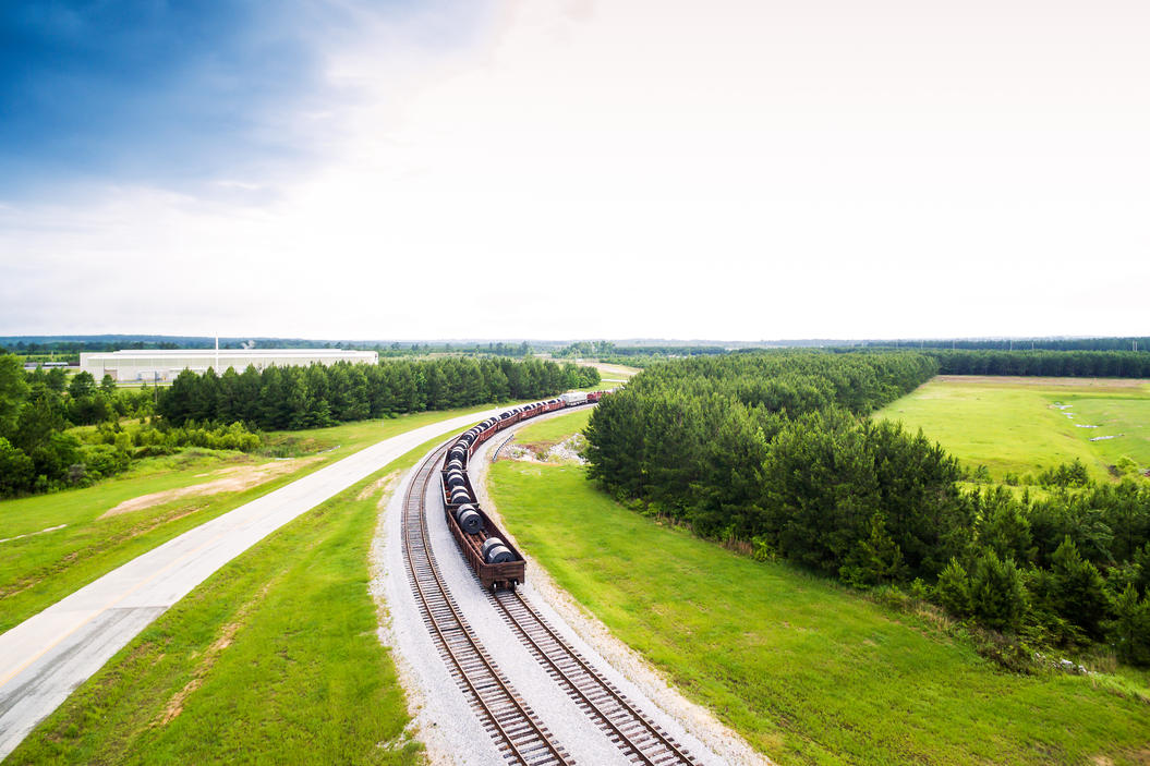 States with the biggest debt problem - Train traveling down a pine tree lined train track in rural Alabama. 