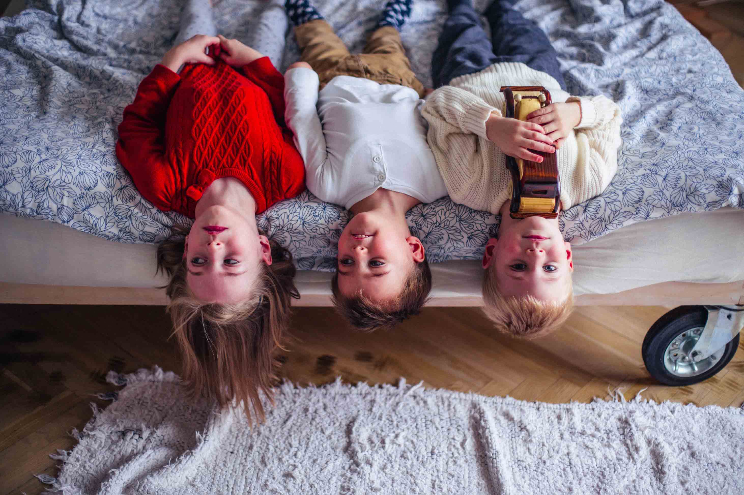 how and when to say no - three kids upside down on a bed