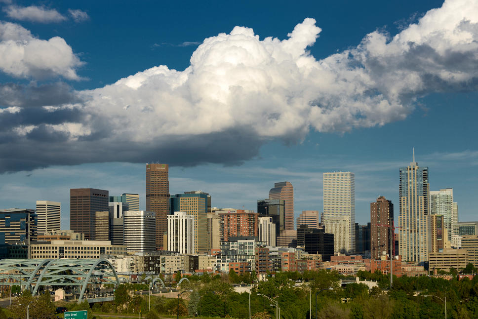 How Much Home Can Millennial Families Afford in These Top Cities? - Denver, CO skyline against a cloudy sky. 