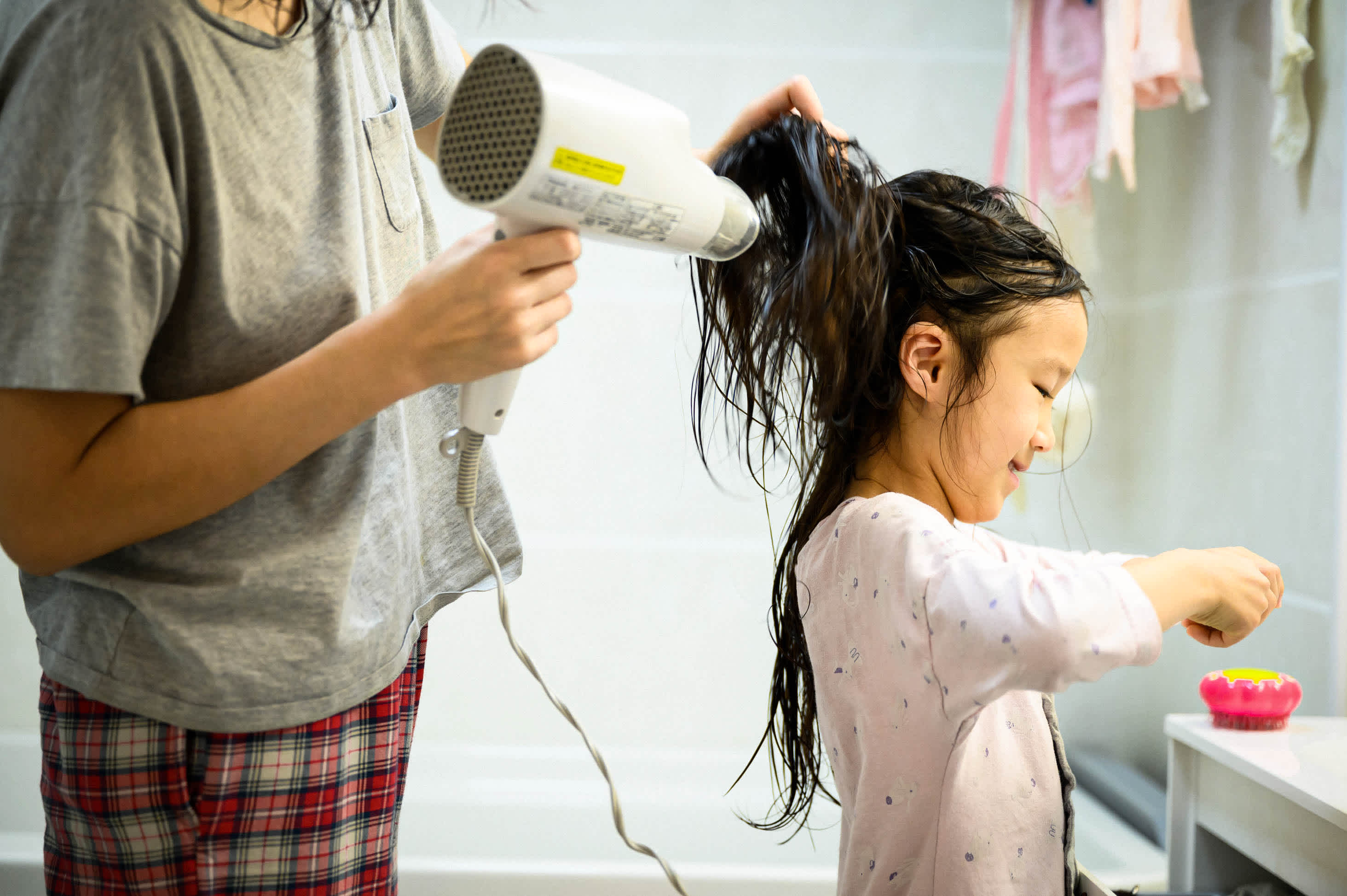 how are parents thinking about estate planning during the coronavirus pandemic? - mother blow drying toddler daughter's wet hair