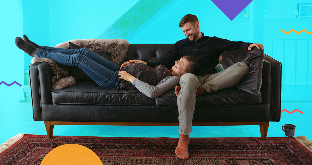 pregnant woman lounging with man on couch - how much home can millennials afford in big cities