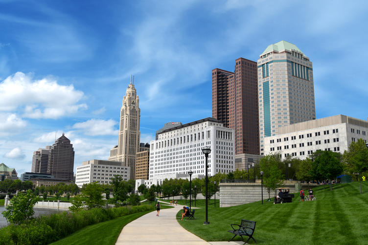 How Much Home Can Millennial Families Afford in These Top Cities? - Columbus downtown skyline against a blue sky. 