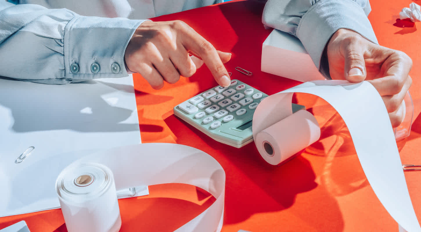 a person reviews the receipt from an adding calculator