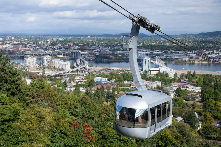 How Much Home Can Millennial Families Afford in These Top Cities? - Cable car traveling up a lush mountain in Portland, OR.