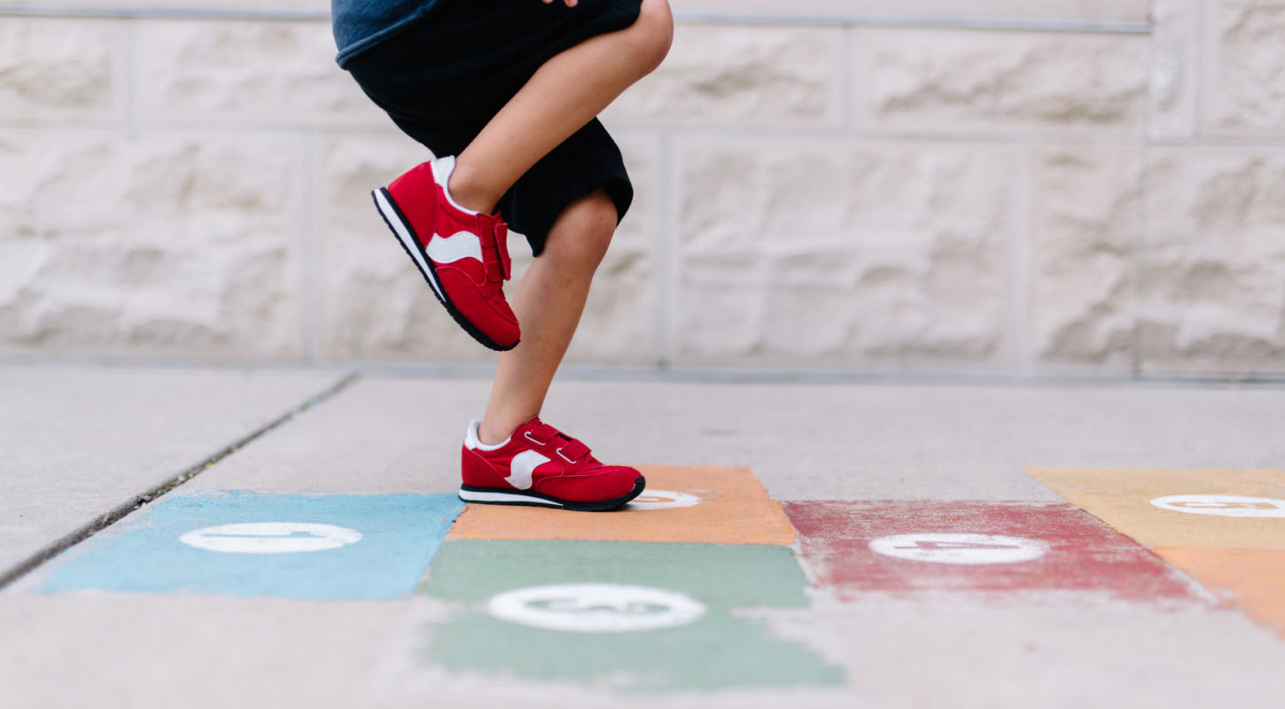 A child plays hopscotch. 