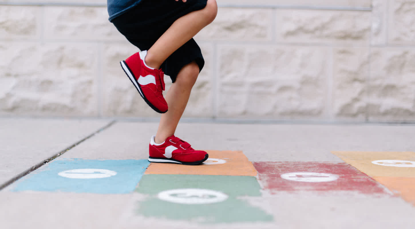 A child plays hopscotch.