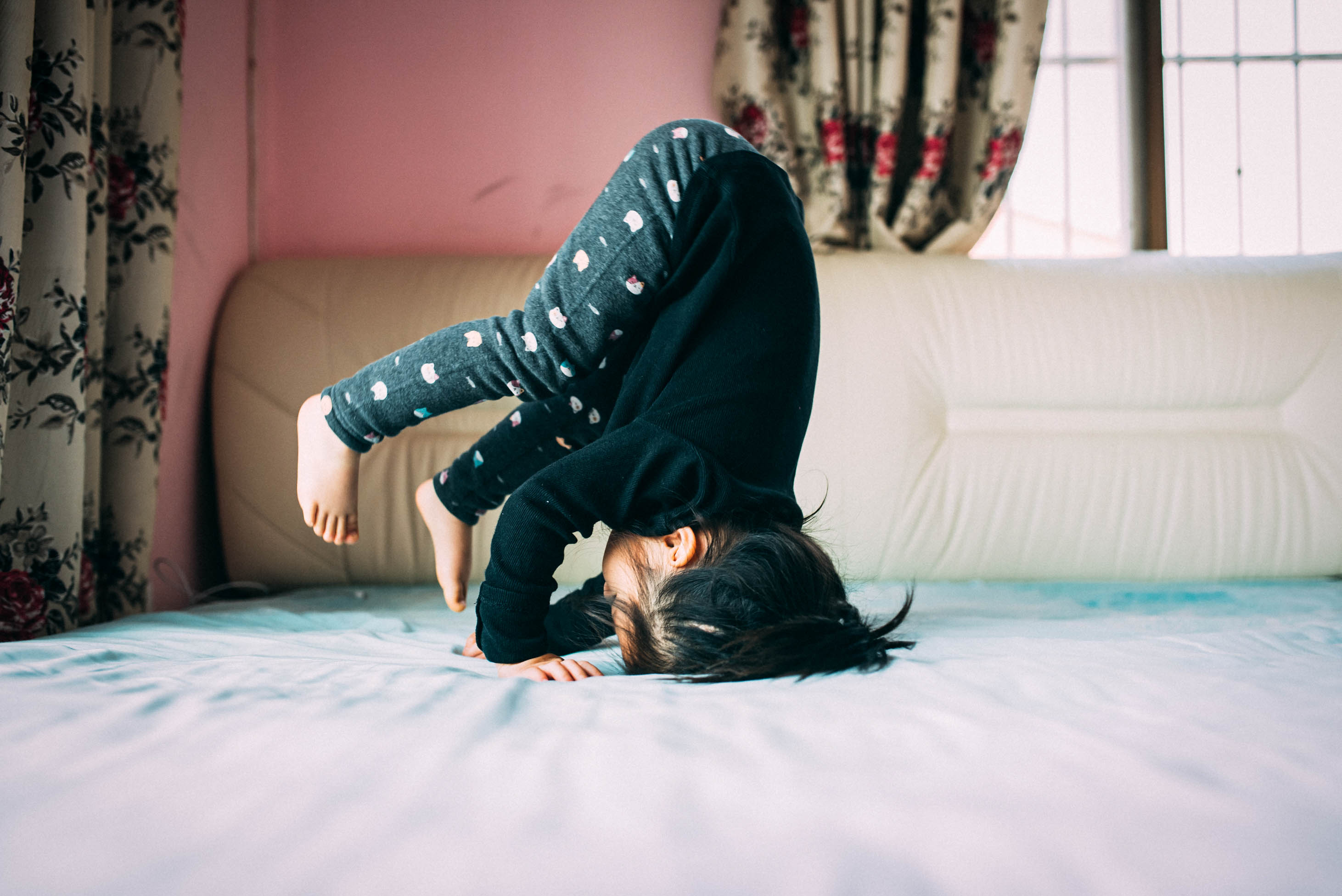 toddler doing a handstand - should you take out a life insurance policy on your kid