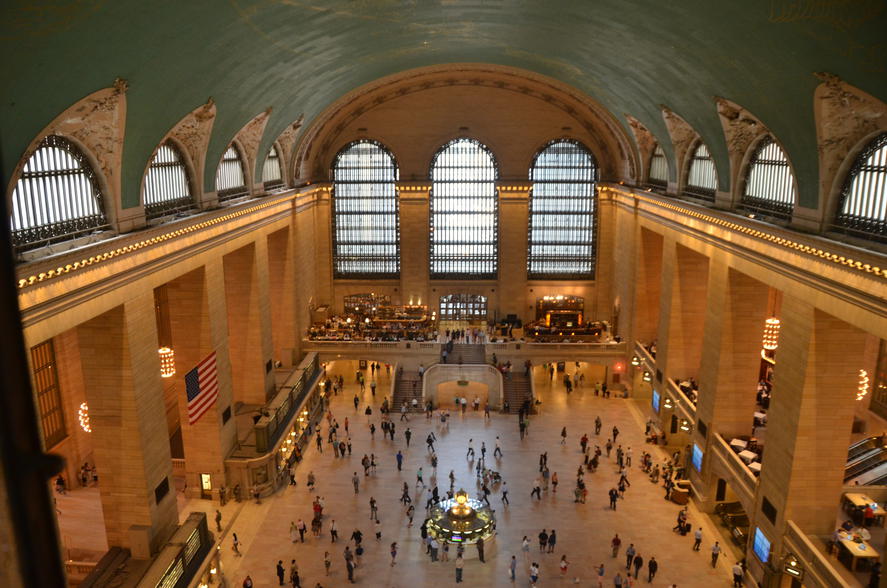 10 Family-Friendly Cities With the Best Public Transit - Birdseye view of commuters bustling through Grand Central Station in New York, NY. 