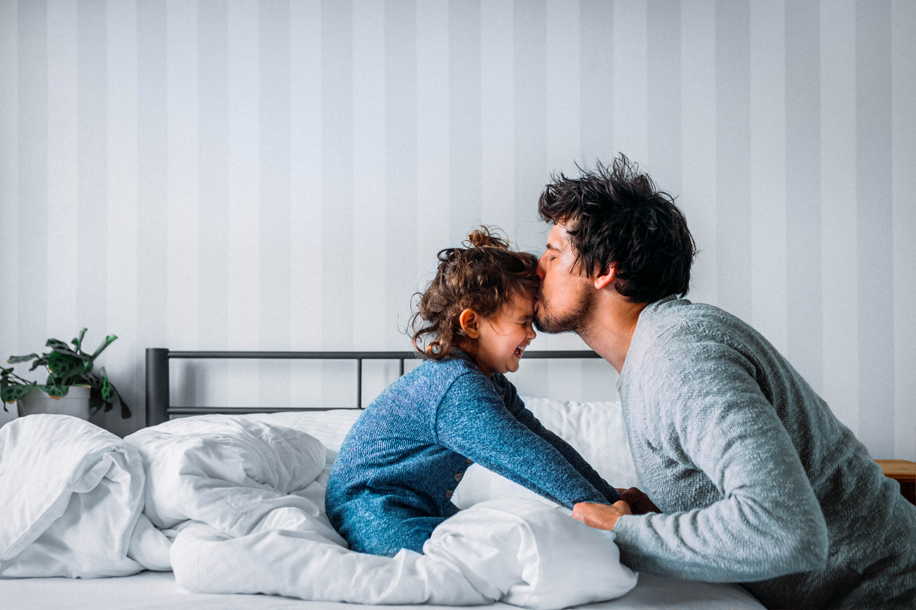 how to decide if you can become a stay at home parent, stay at home mom - father kissing daughter on bed