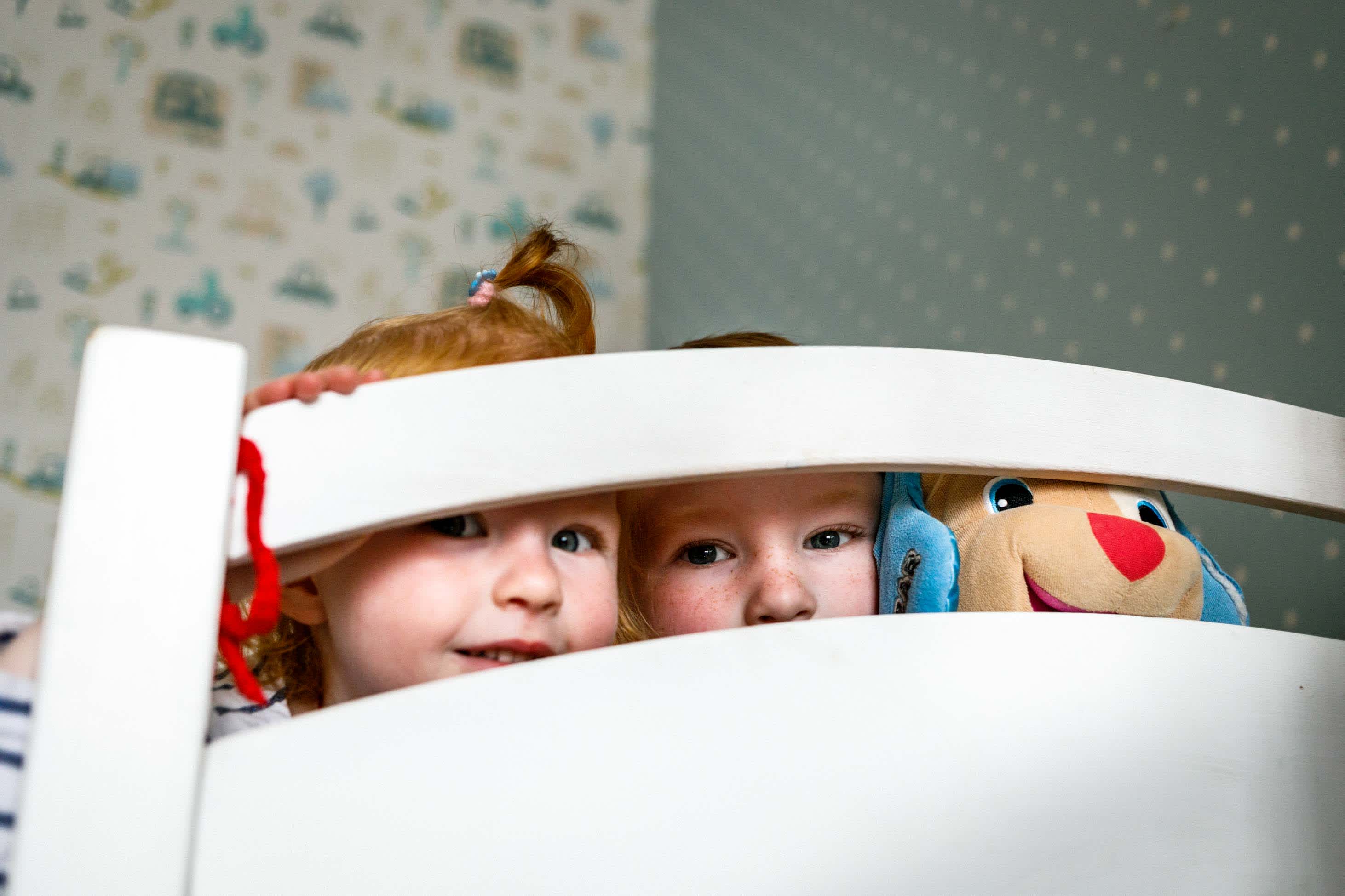 what to know when you have a 3 year old - sleepover party girls peeking over the bed with stuffed animal