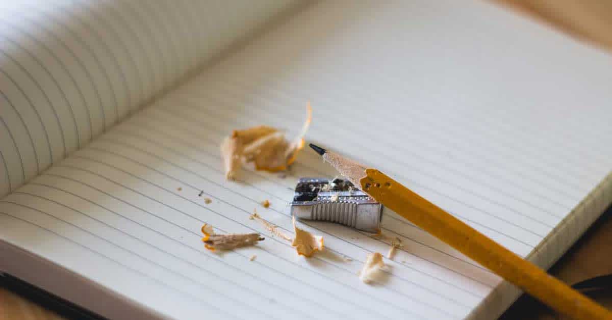 pencil with sharpener and notebook - new parents' financial checklist